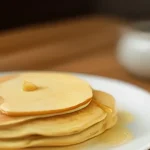 pancakes flat served on a wooden table, freshly made and ready to serve
